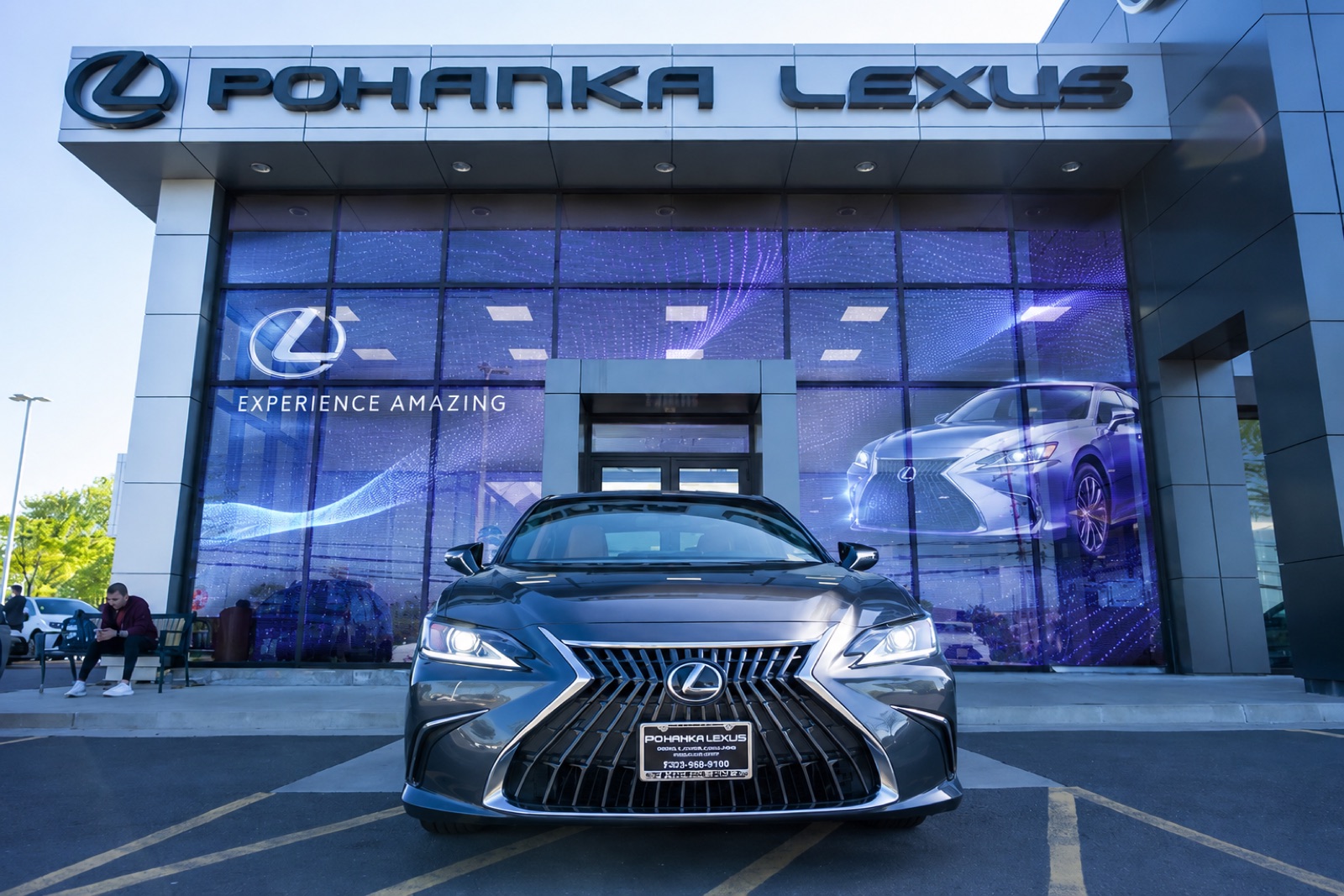 Concept visualization: transparent LED showroom windows behind a dealership forecourt